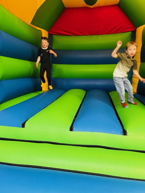 Boys bouncing on a bouncy castle in Telford